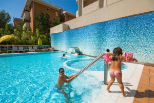 a group of children playing in a swimming pool at Hotel Europa in Bibione