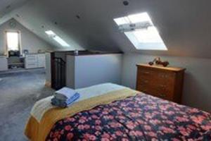 a bedroom with a bed in a attic at Studio Sleeps 2 -Private Hot Tub -Enclosed Garden in Killarney