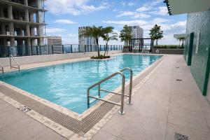 a swimming pool on the roof of a building at Lujoso apartamento ,The Crosby Miami World Center in Miami