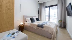 a bedroom with a bed and a large window at Sol Marina 231 in Wiślinka