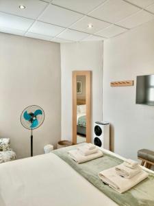 a bedroom with a bed with two towels on it at The Botanic High Gold in Paarl