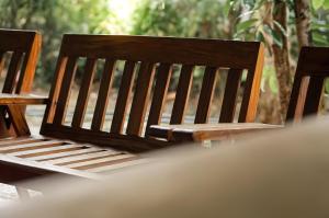 a wooden bench sitting on top of a table at Dan Sewana in Nochchiyagama