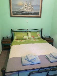 a bedroom with a bed with two towels on it at Mimi's House 2 in Véssa +20 photos