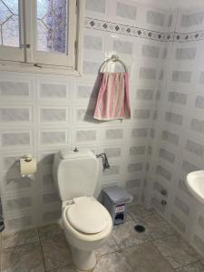 a bathroom with a toilet and a sink at Mimi's House 2 in Véssa