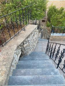 a set of stairs with a railing and a stair case at Mimi's House 2 in Véssa