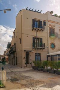 a building with balconies on the side of it at La Piazzetta Sea Rooms in Balestrate