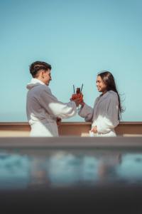 a man and a woman holding a pair of scissors at La Piazzetta Sea Rooms in Balestrate