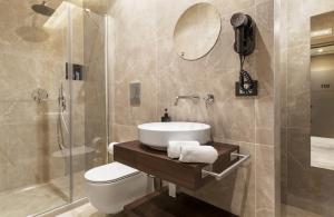 a bathroom with a sink and a toilet and a shower at La Piazzetta Sea Rooms in Balestrate +39 photos