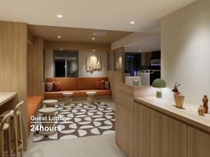 a kitchen with a living room with a couch at Mitsui Garden Hotel Sapporo in Sapporo