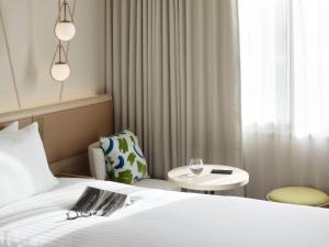 a hotel room with a bed and a chair and a table at Mitsui Garden Hotel Sapporo in Sapporo +55 photos