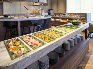 a buffet line with many different types of food at Mitsui Garden Hotel Sapporo in Sapporo