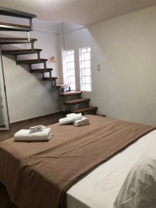 a bedroom with a bed with two towels on it at Πέτρινη φωλιά in Livadi