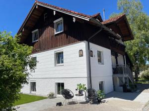 a large white house with a brown roof at Ferienhaus Ferienwohnung CasaBergZeit mit Königscard im Allgäu, Pfronten, Füssen in Pfronten +21 photos
