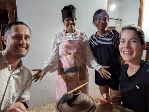 a group of people standing around a woman in an apron at Abha Sewana අඹ සෙවණ in Anuradhapura