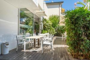 a patio with a table and chairs on a deck at Hotel Consul - Family Hotel in Riccione