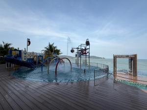 a water park with a water slide on a boardwalk at Swiss Cozy Studio Kuantan City View Imperium Residence in Kuantan