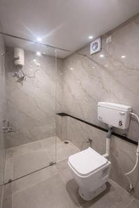 a bathroom with a toilet and a shower at erode kongu mess in Chennai