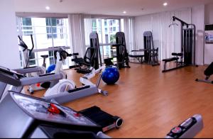 a gym with several treadmills and exercise bikes at สุขุมวิท101 By KT in Amphoe Phra Khanong