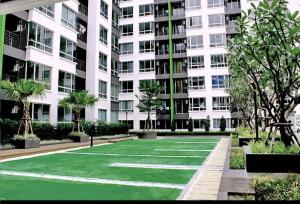 a green lawn in front of a building at สุขุมวิท101 By KT in Amphoe Phra Khanong