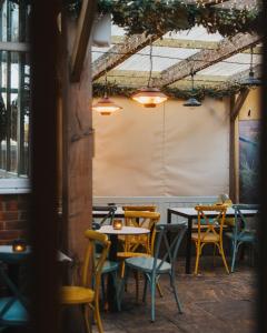 a group of tables and chairs in a restaurant at Tower Hotel in Lincoln