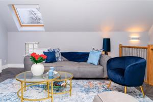 a living room with a couch and a table at The Gleneagles Hideaway - Luxury 3 Bed With Complimentary Access to Onsite Leisure Facilities in Gleneagles Station