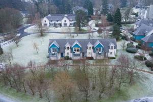 an aerial view of a house with snow on the ground at The Gleneagles Hideaway - Luxury 3 Bed With Complimentary Access to Onsite Leisure Facilities in Gleneagles Station