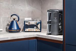a coffee maker and a tea kettle on a counter at The Gleneagles Hideaway - Luxury 3 Bed With Complimentary Access to Onsite Leisure Facilities in Gleneagles Station