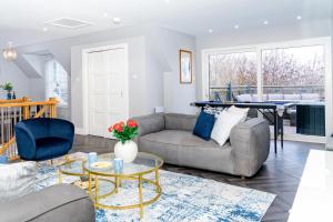 a living room with a couch and a table at The Gleneagles Hideaway - Luxury 3 Bed With Complimentary Access to Onsite Leisure Facilities in Gleneagles Station