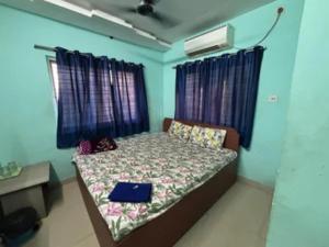 a bedroom with a bed with a laptop on it at Via Ashiyana Inn in Kolkata