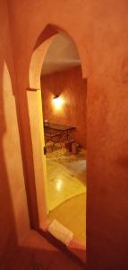 an archway leading into a room with a bench at Hotel L'Astrolabe in Oloron-Sainte-Marie
