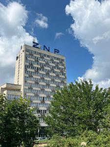 a tall building with the word inn on top of it at Hotel Logos in Warsaw