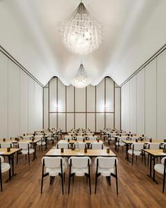 a large room with tables and chairs and chandeliers at Virgin Hotels Dallas in Dallas +132 photos