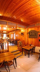 a restaurant with wooden tables and wooden ceilings at Goblec Otel in Uzungöl