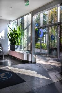 a lobby of a building with large glass doors at Hotel Logos in Warsaw