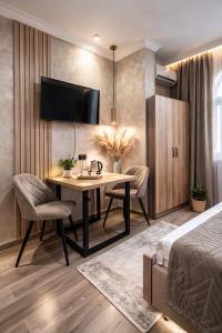 a bedroom with a desk and a tv on a wall at Old Yerevan by IGIT in Yerevan