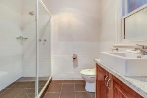 a bathroom with a toilet and a sink and a shower at Seymours On Lydiard in Ballarat +40 photos