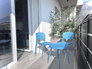 two blue chairs and a table on a balcony at Jungle - Sarnico Color Suites in Sarnico +16 photos