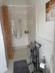 a bathroom with a shower with a shower curtain at Crispin House in Hunstanton +26 photos