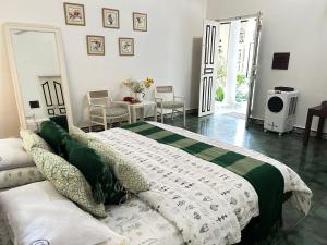 a bedroom with a bed and a table and chairs at Crepe Ginger Home Stays in Hariharpur