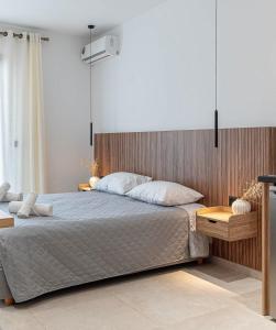 a bedroom with a large bed and a chair at Elysian Studio A2 in Karpathos +17 photos