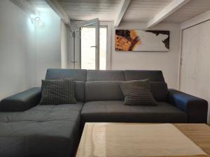 a living room with a couch and a table at La casa della nonna by LoveSud in Castrignano del Capo