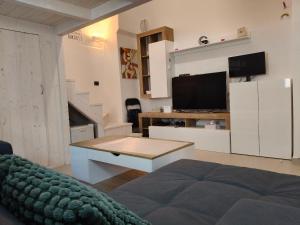 a living room with a couch and a table at La casa della nonna by LoveSud in Castrignano del Capo