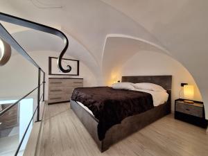 a bedroom with a bed with an arched ceiling at La casa della nonna by LoveSud in Castrignano del Capo +20 photos
