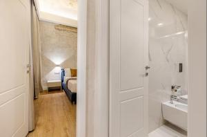 a bathroom with a door leading to a bedroom with a bed at The Place 217 in Rome +58 photos