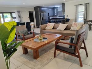 a living room with a couch and a table at Petalite villa in Maun