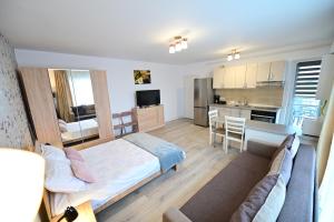 a living room with a bed and a kitchen at FLH - Binder Lake View with AC in Sibiu