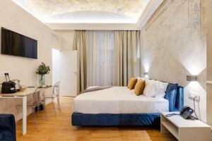 a hotel room with a bed and a desk at The Place 217 in Rome