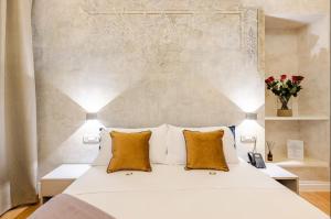 a bedroom with a white bed with orange pillows at The Place 217 in Rome
