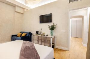 a room with a bed and a couch and a tv at The Place 217 in Rome