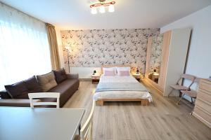 a living room with a couch and a bed at FLH - Binder Lake View with AC in Sibiu